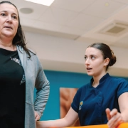 Physiotherapist supporting a patient during rehabilitation exercises at Revive Physio Centre in Malta